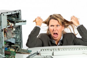 Woman pulls her hair out over her broken computer